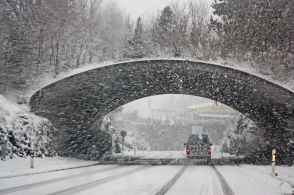photo of white vehicle crossing a tunnel